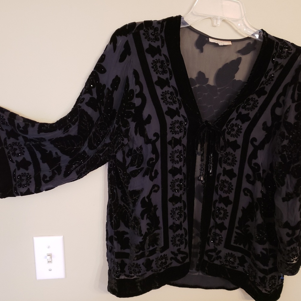 Cute lightweight sheer top with tassle ties..